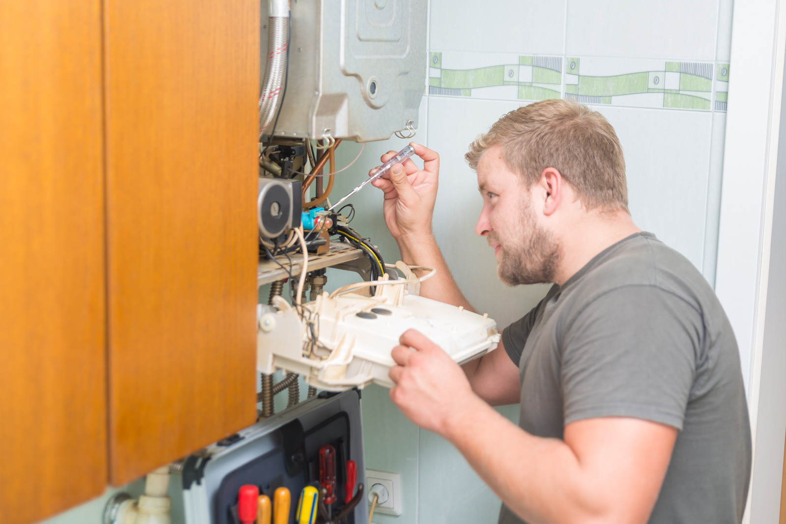 Technician repairing Furnace in Surrey