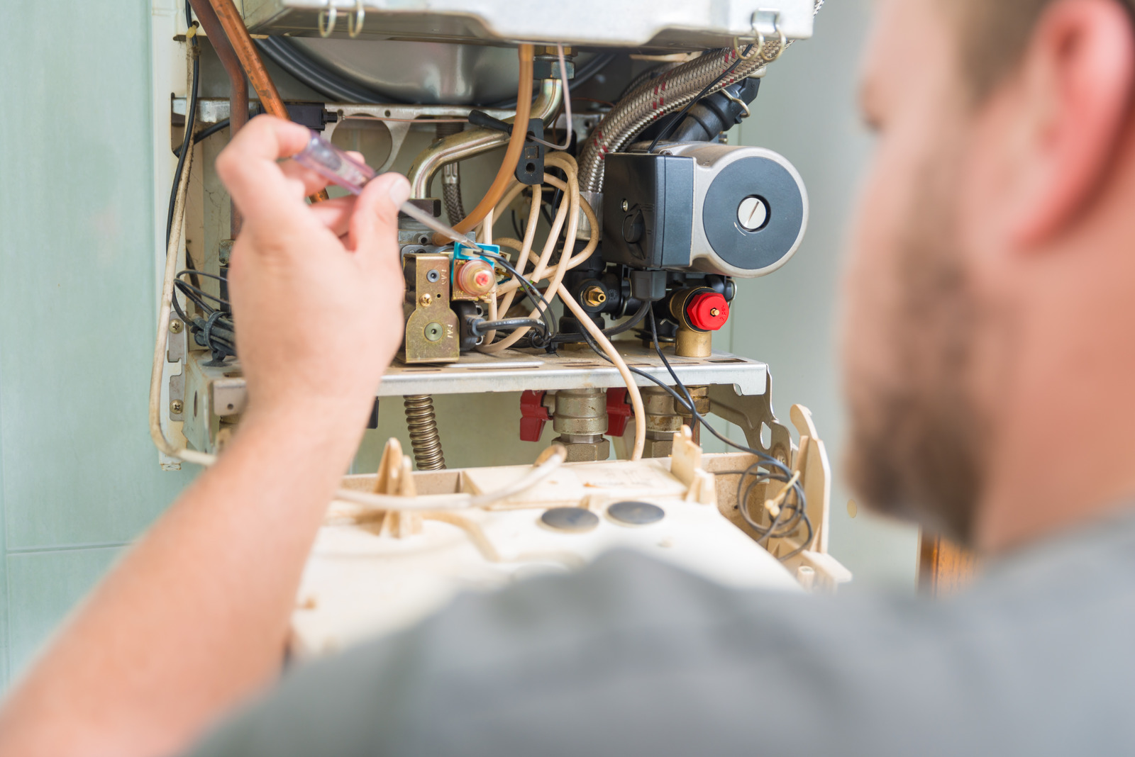 Technician repairing Gas Furnace in Surrey