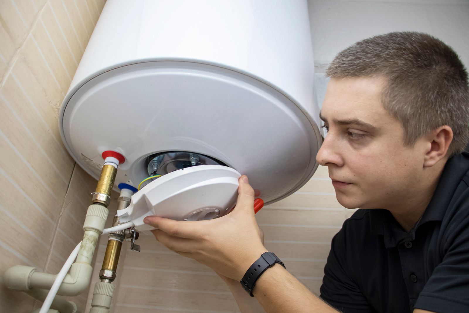 a man repairing water heater in Surrey