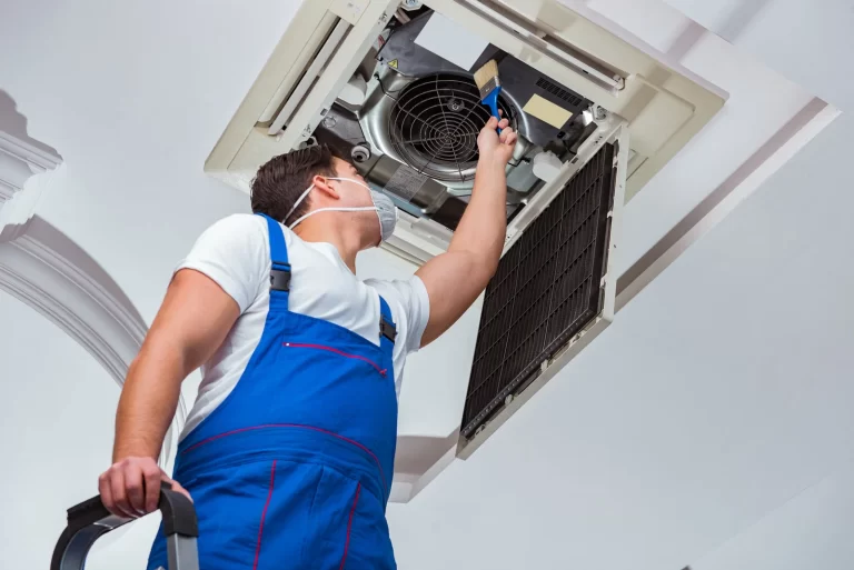 a worker repairing AC in Langley