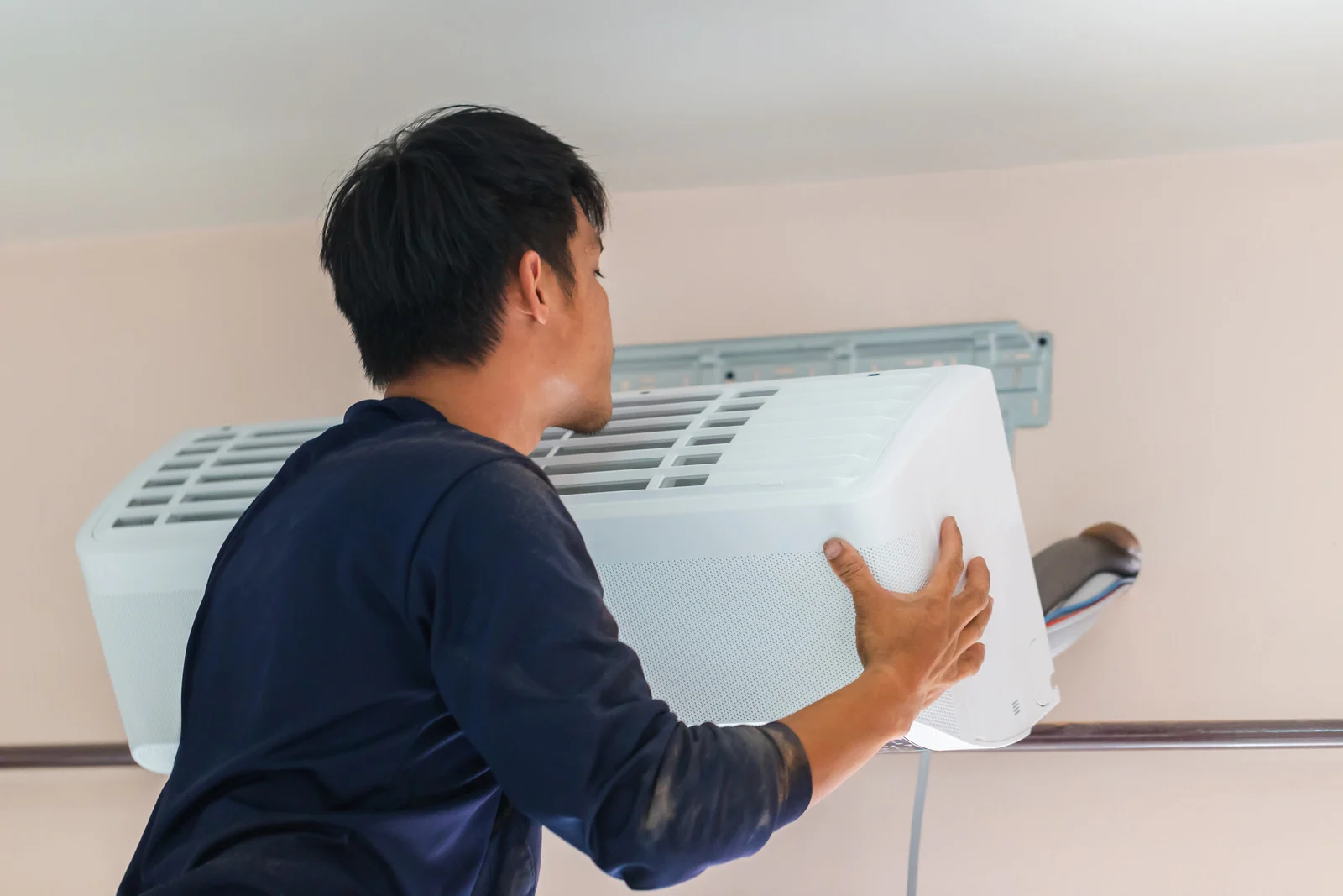 AC Installation Surrey technician installing in spring