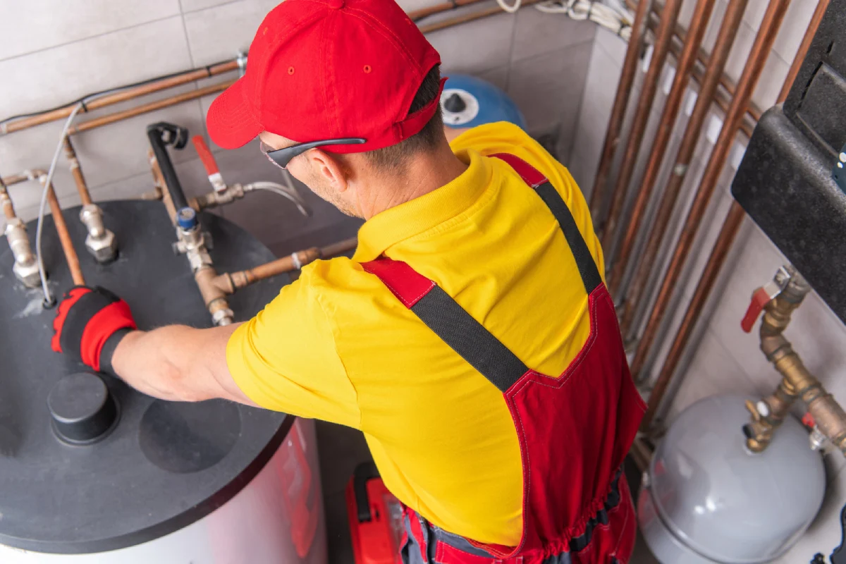 plumber fixing hot water tank repair in Surrey