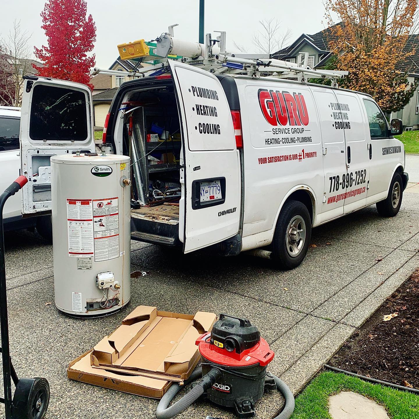 Surrey BC hot water tank installation with Guru Service Group van on-site