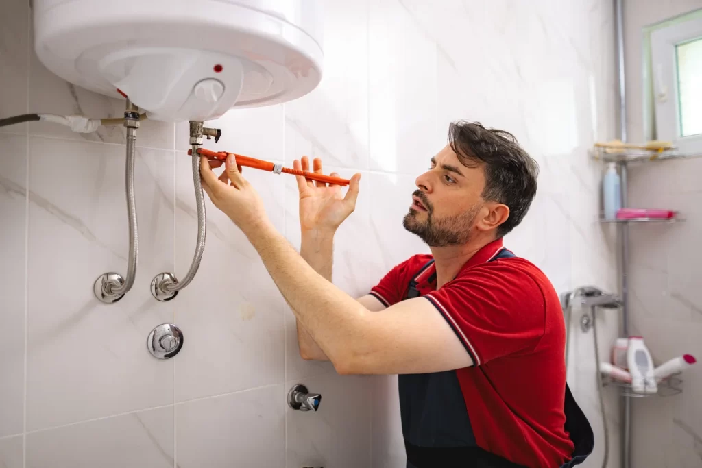 Guru Service Group technician repairing hot water tank in Surrey
