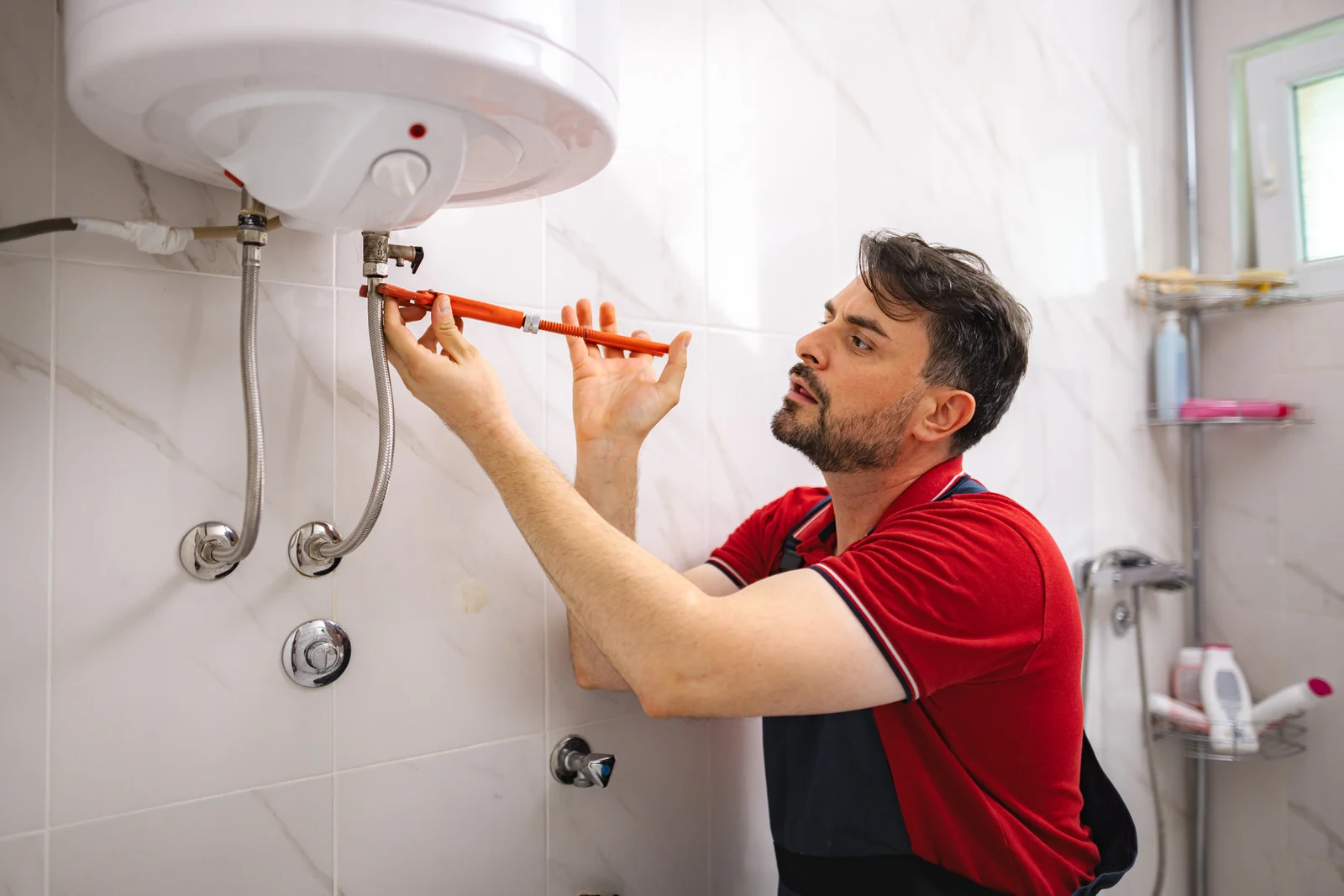Guru Service Group technician repairing hot water tank in Surrey