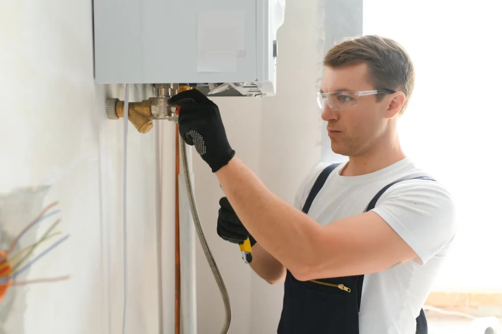 Guru Service Group expert installing tankless water heater components in Surrey home